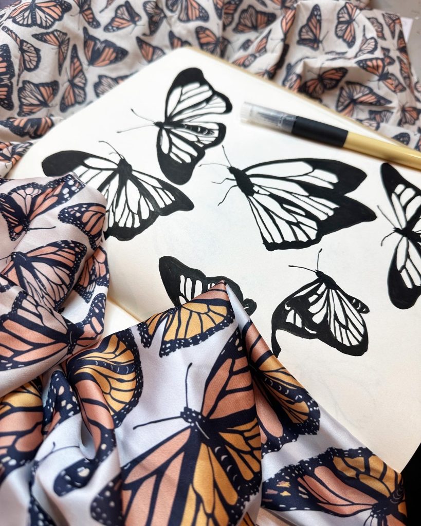 Rebekah Lowell's monarch butterfly surface pattern drawn in a book and printed on fabric.