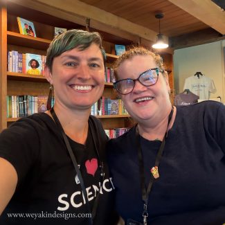 Author/illustrators Victoria K. Chapman and Katie Mazeika stand together smiling in the Boyds Mills book shop in the Barn.